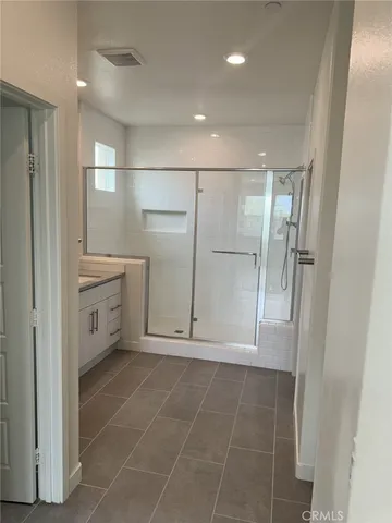 a bathroom with a shower and a sink