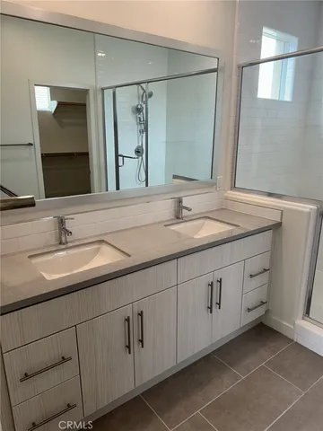 a bathroom with a double vanity sink and mirror