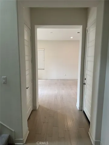 an empty room with wooden floor and door