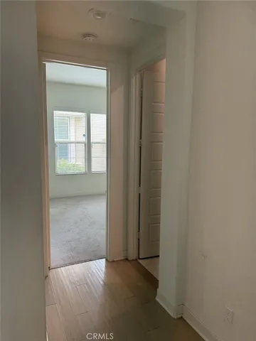 an empty room that has a wooden door