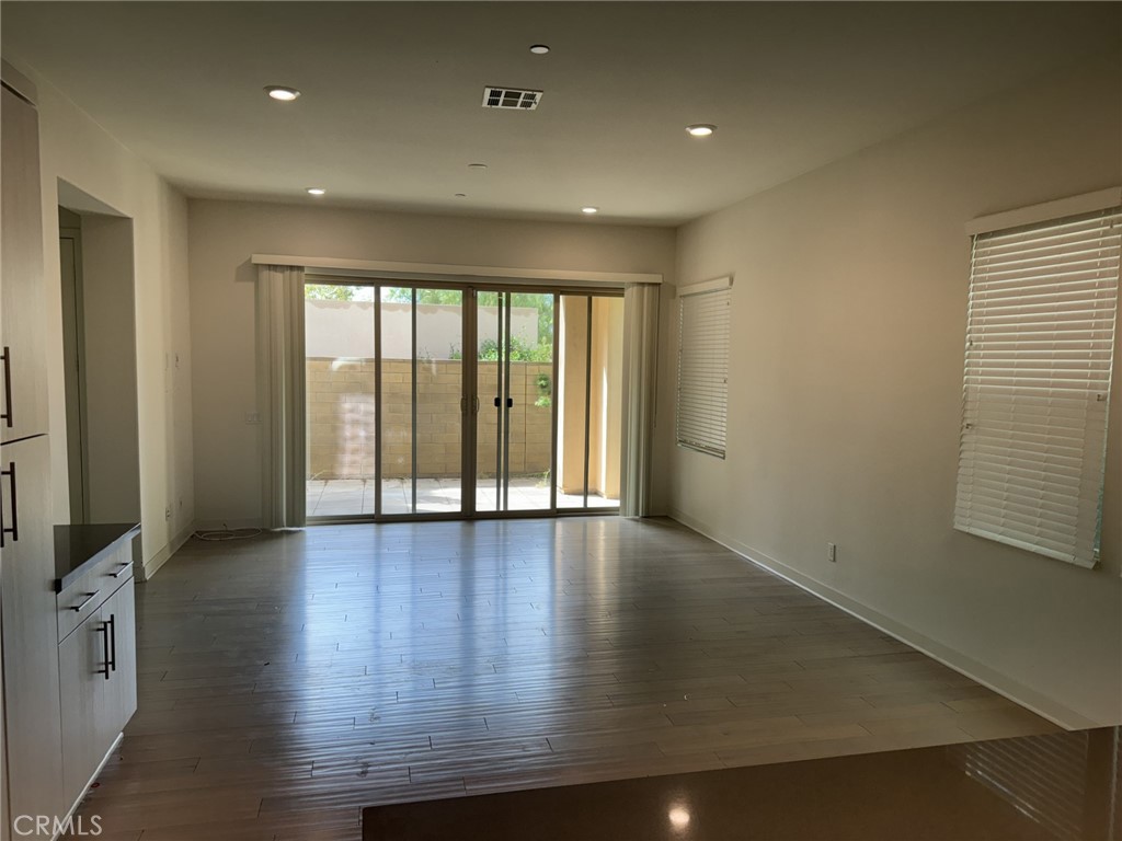 233 Radial Irvine, CA 92618 - Photo 3 of 27 an empty room with wooden floor and windows