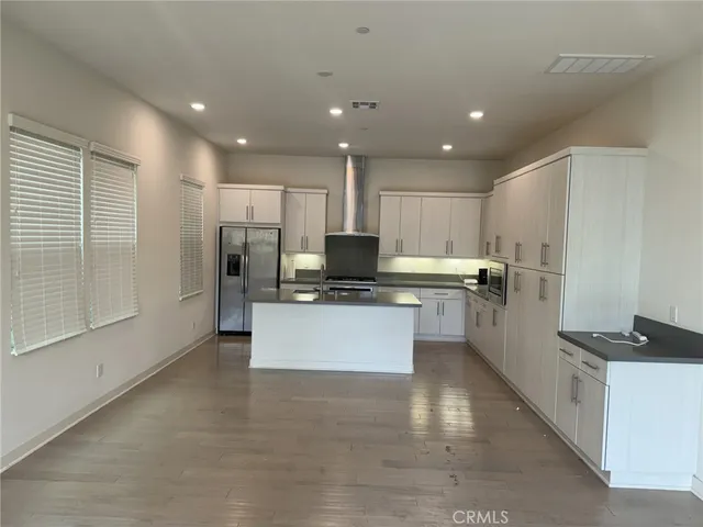 a large kitchen with a large counter top appliances and cabinets