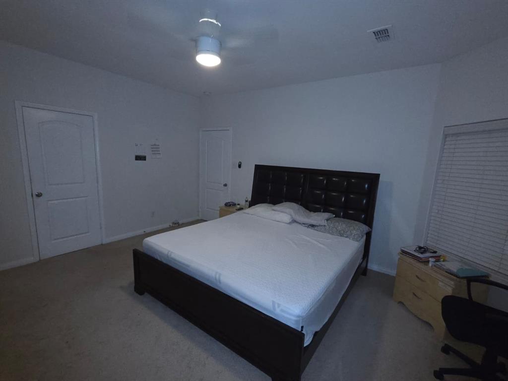 14249 Bridgeview Lane Dallas, TX 75253 - Photo 3 of 9 Carpeted bedroom with baseboards and ceiling fan