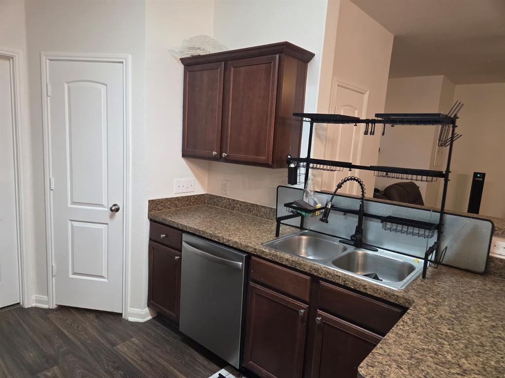 14249 Bridgeview Lane Dallas, TX 75253 - Photo 6 of 9 Kitchen with dark brown cabinets, dark countertops, dishwasher, and dark wood-style flooring