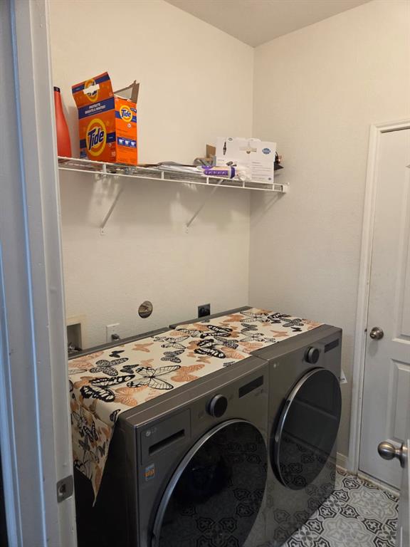14249 Bridgeview Lane Dallas, TX 75253 - Photo 7 of 9 Washroom featuring tile patterned floors and washer and clothes dryer