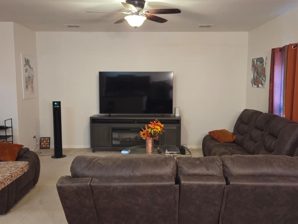 14249 Bridgeview Lane Dallas, TX 75253 - Photo 8 of 9 Living room with ceiling fan and carpet
