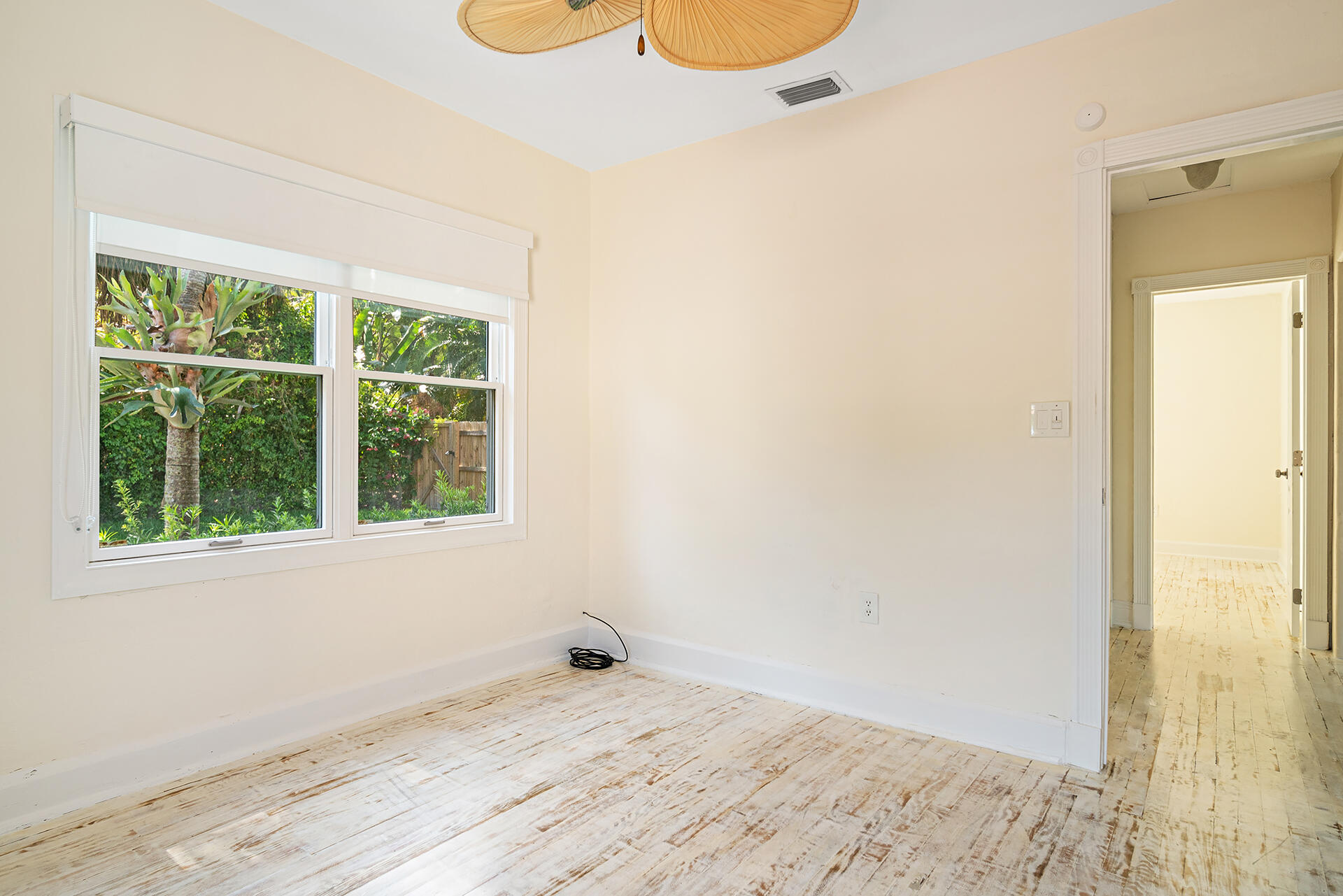 813 Avon Road West Palm Beach, FL 33401 - Photo 15 of 43 an empty room with wooden floor and windows