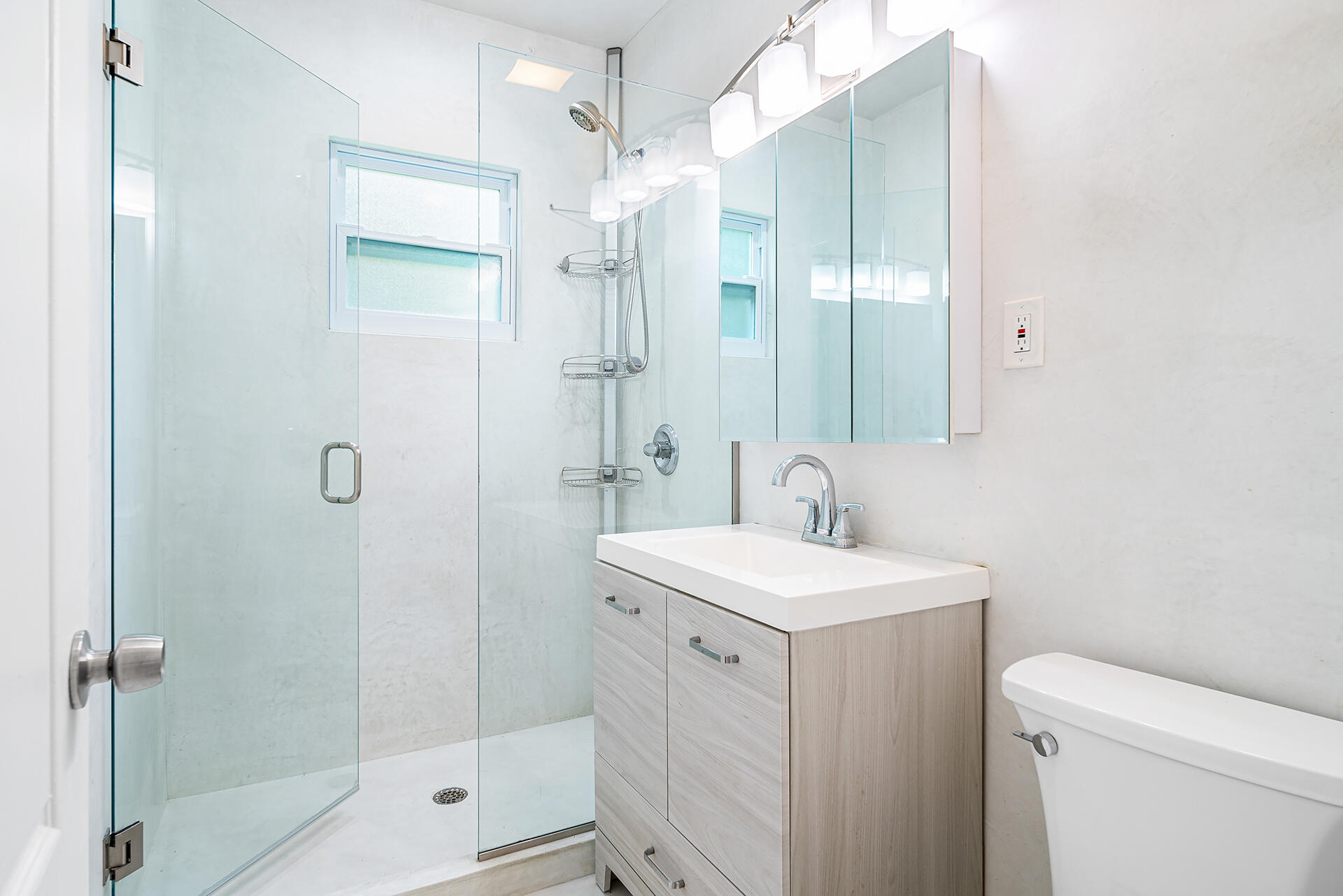 813 Avon Road West Palm Beach, FL 33401 - Photo 17 of 43 a bathroom with a sink a toilet and shower