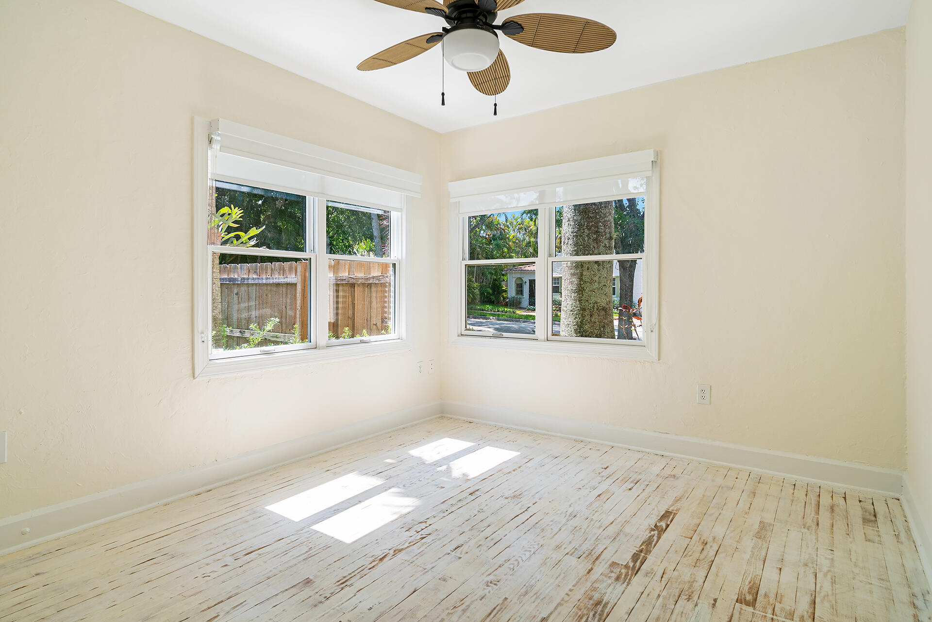 813 Avon Road West Palm Beach, FL 33401 - Photo 19 of 43 a view of an empty room with wooden floor and a window