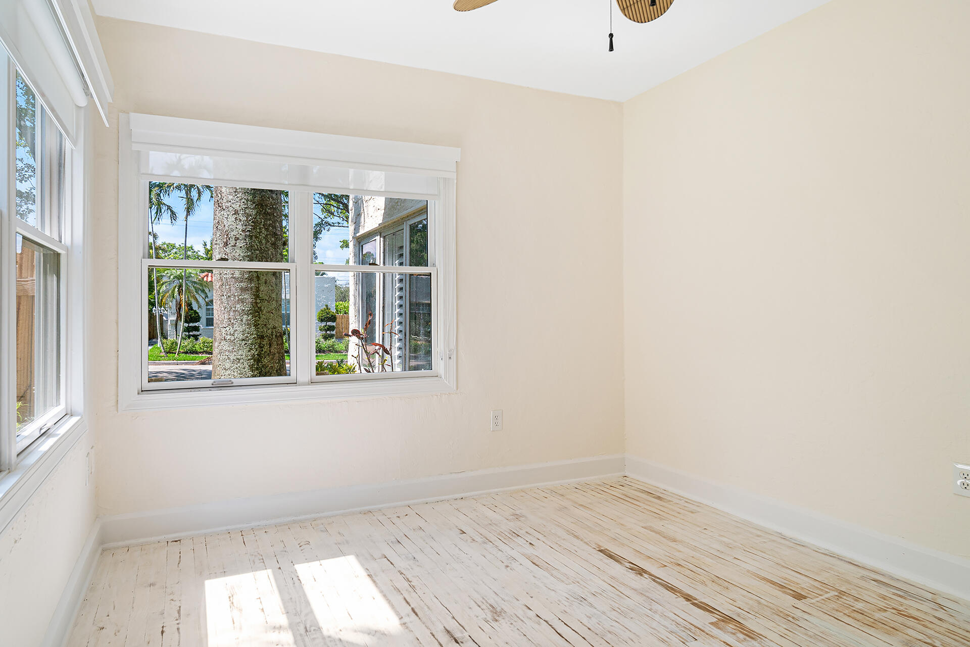 813 Avon Road West Palm Beach, FL 33401 - Photo 20 of 43 an empty room with wooden floor and windows