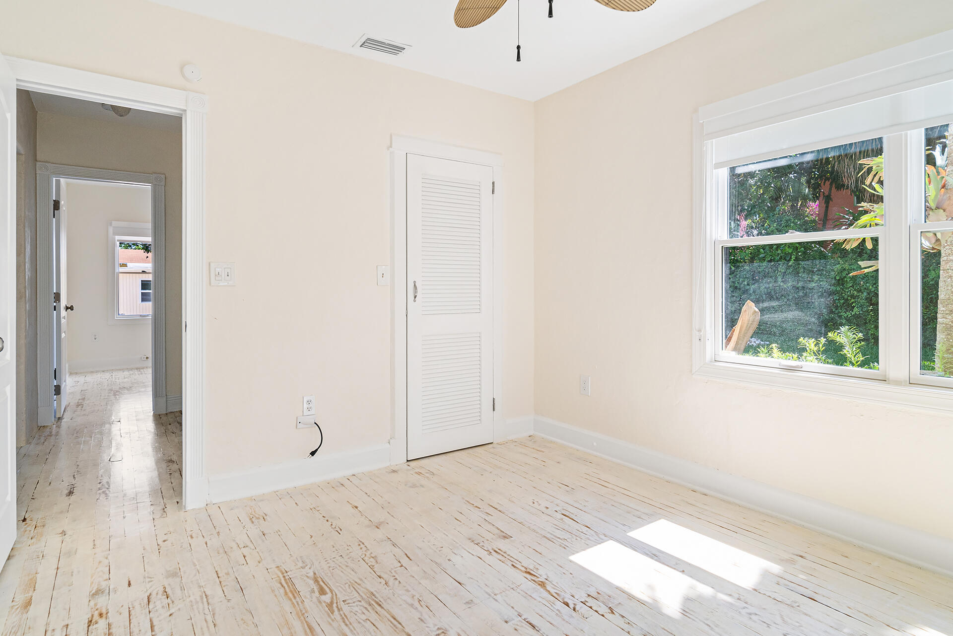 813 Avon Road West Palm Beach, FL 33401 - Photo 21 of 43 an empty room with wooden floor and windows