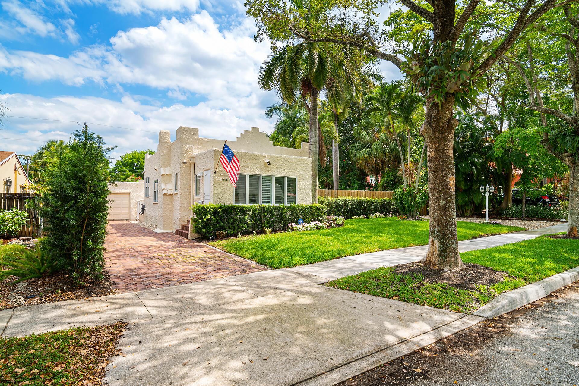 813 Avon Road West Palm Beach, FL 33401 - Photo 22 of 43 a front view of a house with a garden and tree