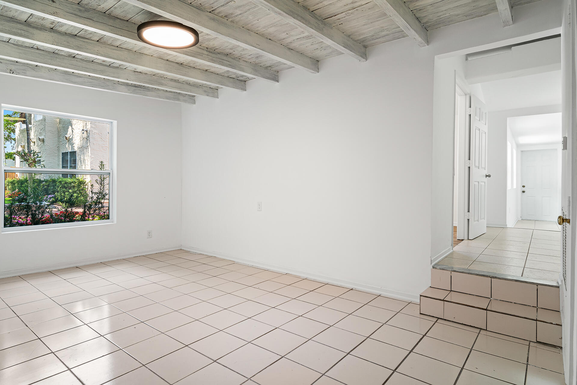 813 Avon Road West Palm Beach, FL 33401 - Photo 31 of 43 a view of a livingroom with an empty space and a window