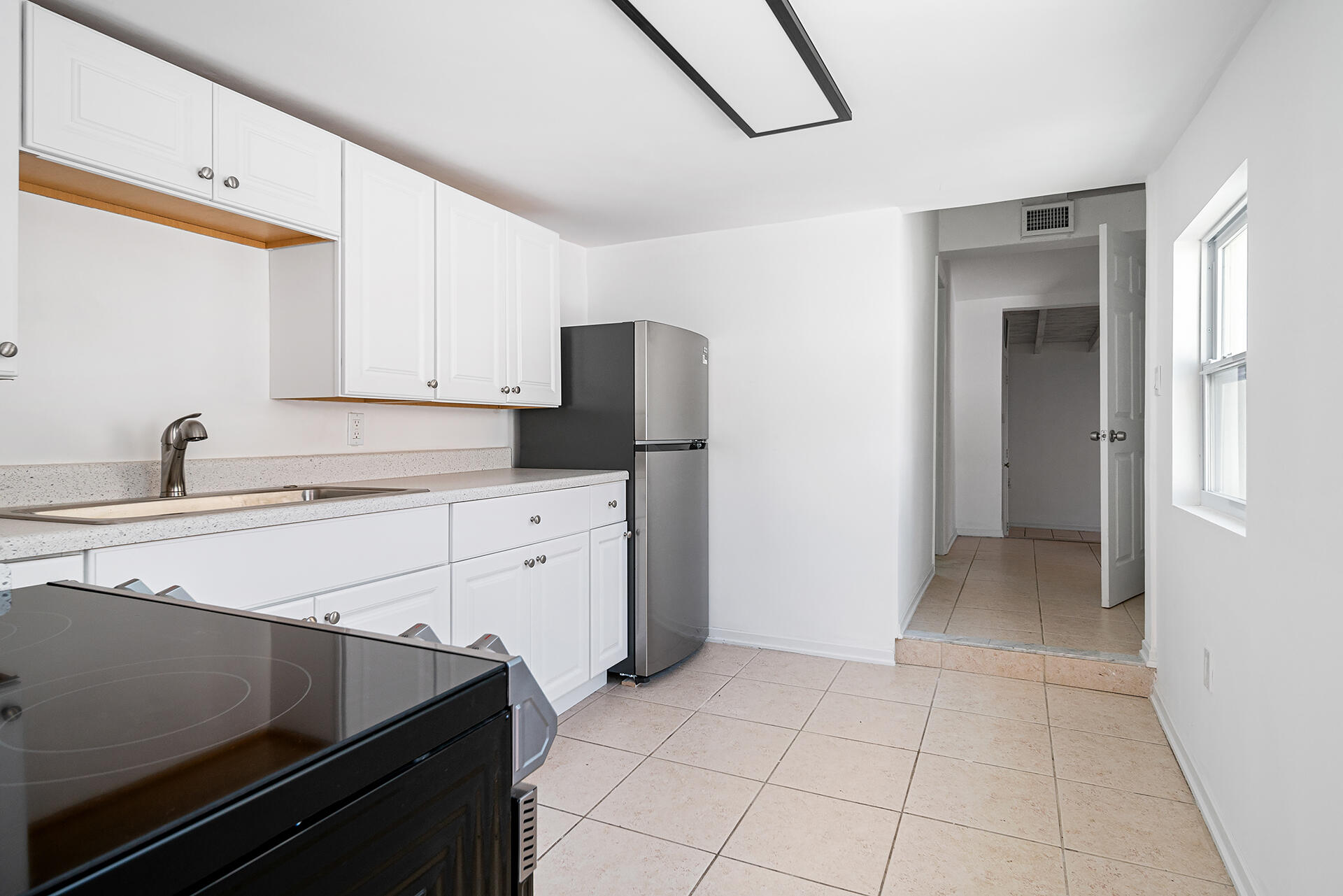 813 Avon Road West Palm Beach, FL 33401 - Photo 32 of 43 a kitchen with appliances cabinets and a sink