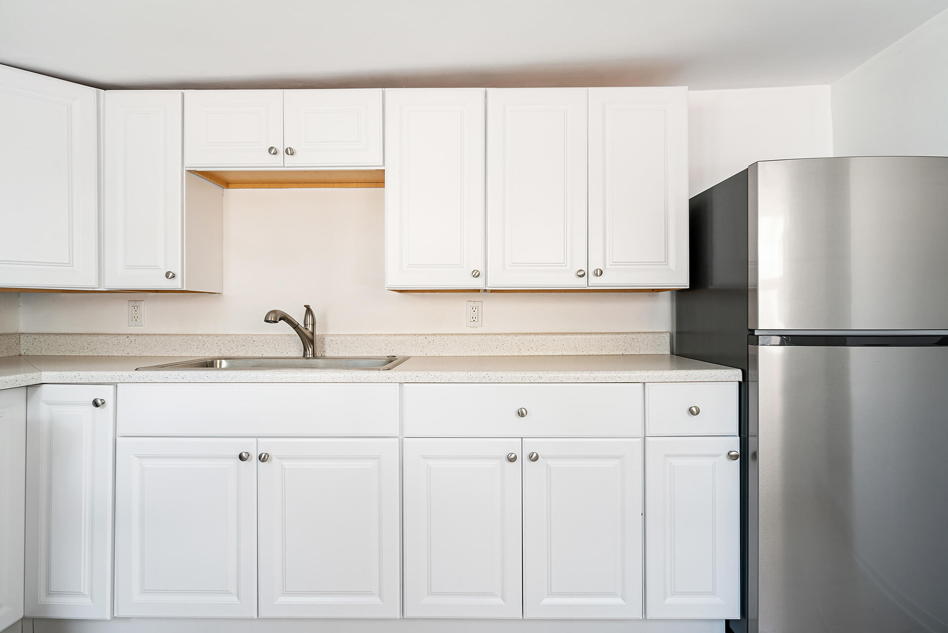 813 Avon Road West Palm Beach, FL 33401 - Photo 34 of 43 a kitchen with white cabinets and refrigerator