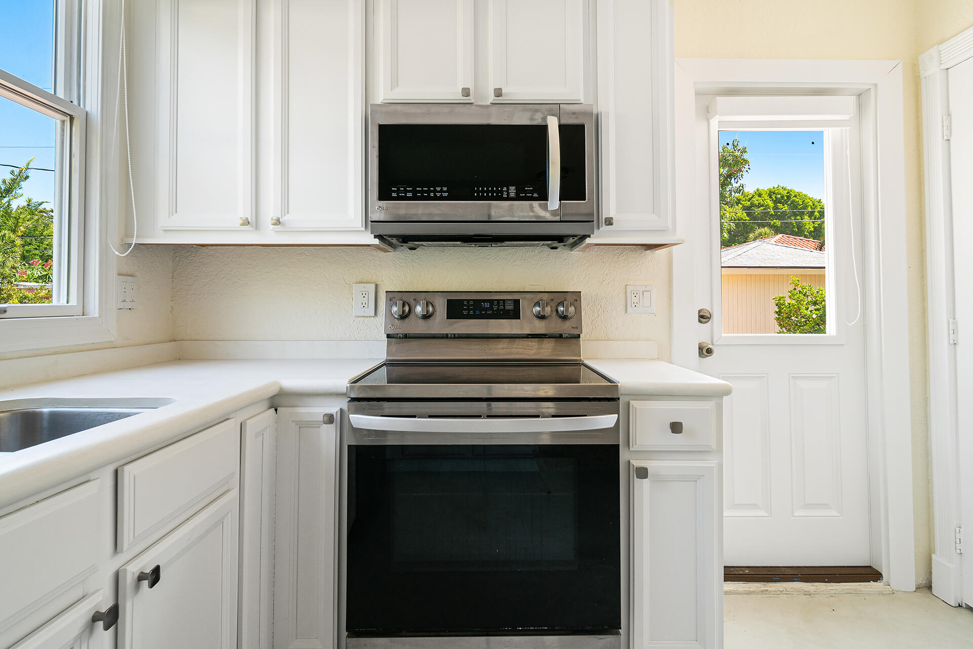 813 Avon Road West Palm Beach, FL 33401 - Photo 35 of 43 a stove top oven sitting inside of a kitchen