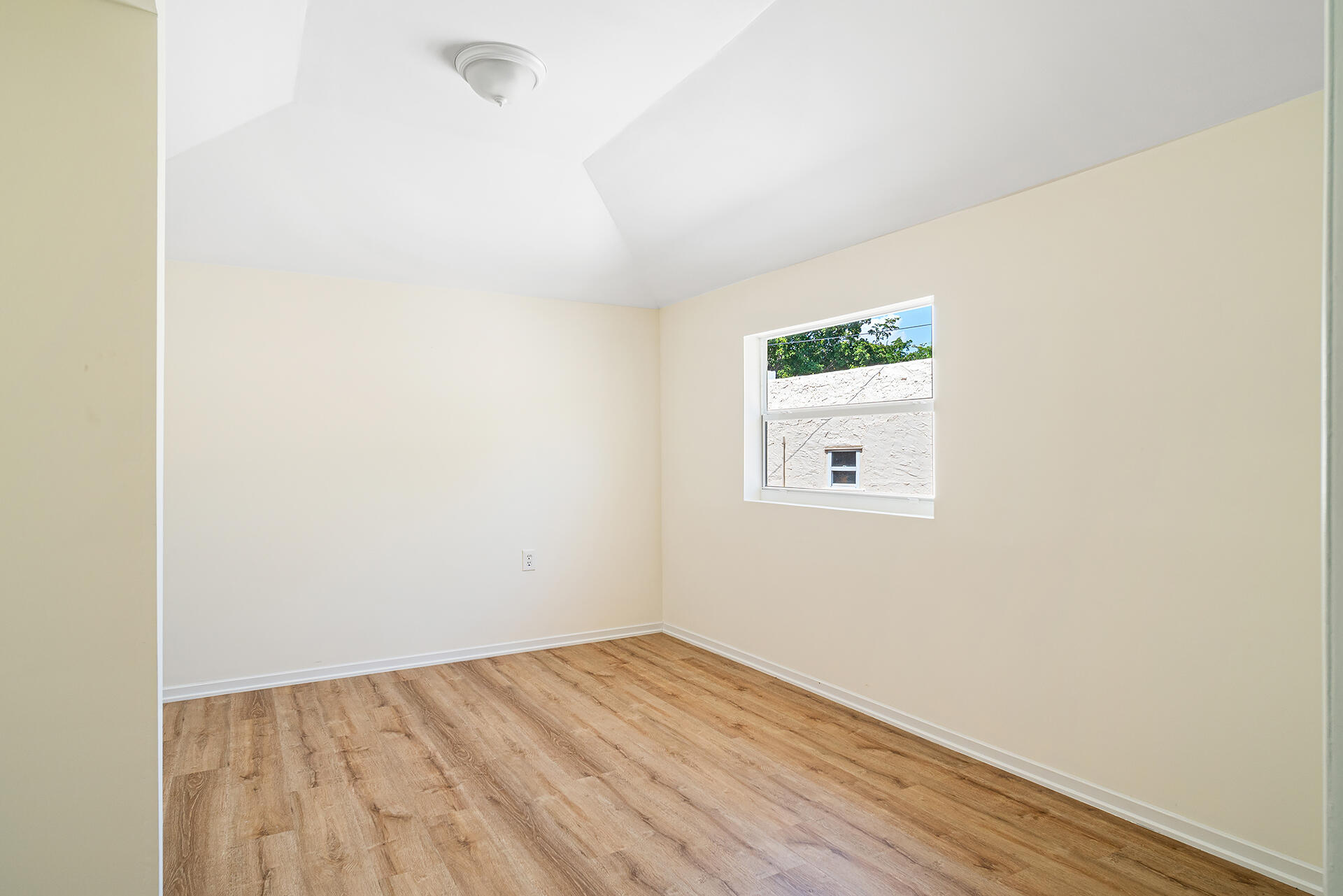 813 Avon Road West Palm Beach, FL 33401 - Photo 38 of 43 a room with a window and wooden floor
