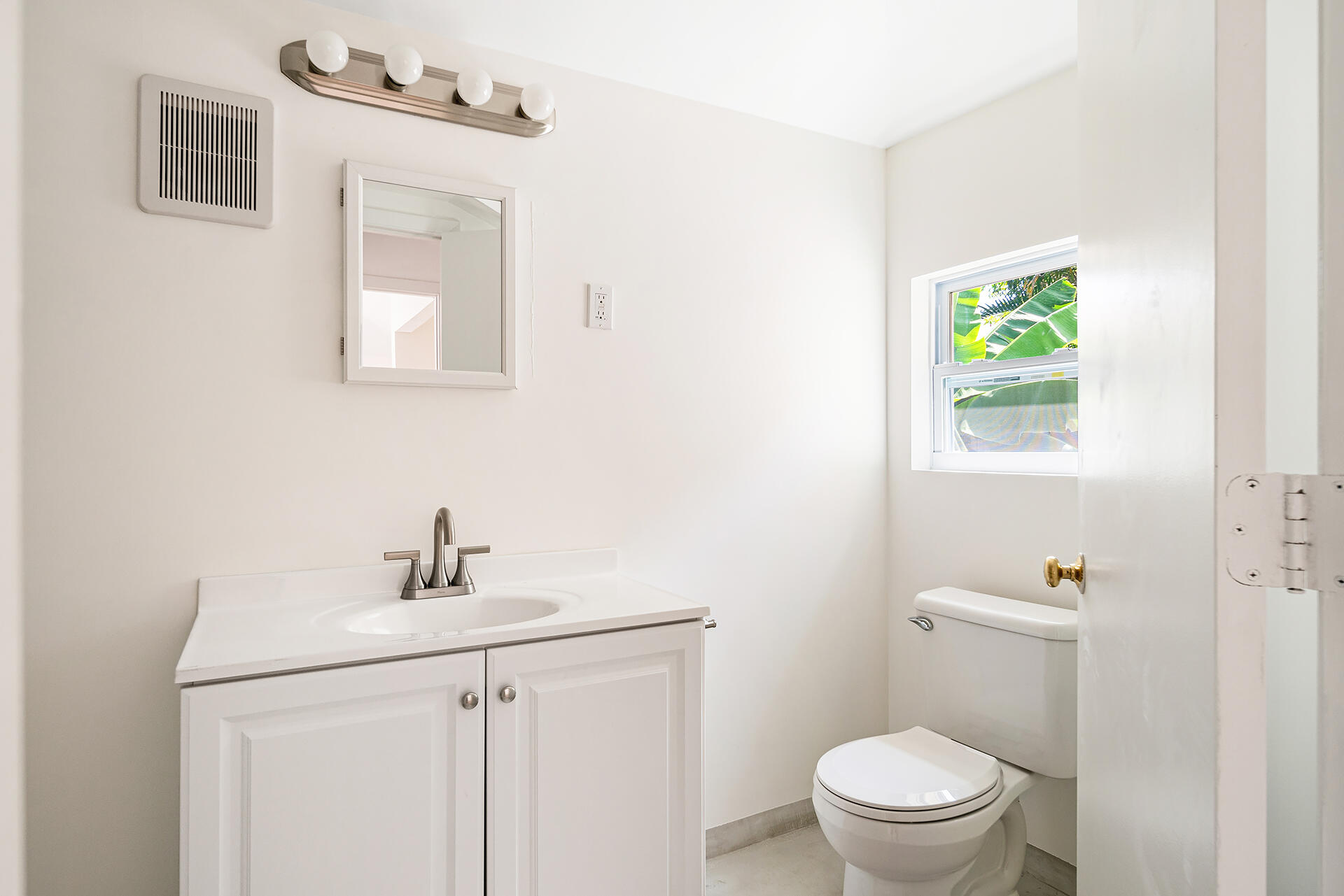 813 Avon Road West Palm Beach, FL 33401 - Photo 40 of 43 a white toilet sitting next to a bathroom sink