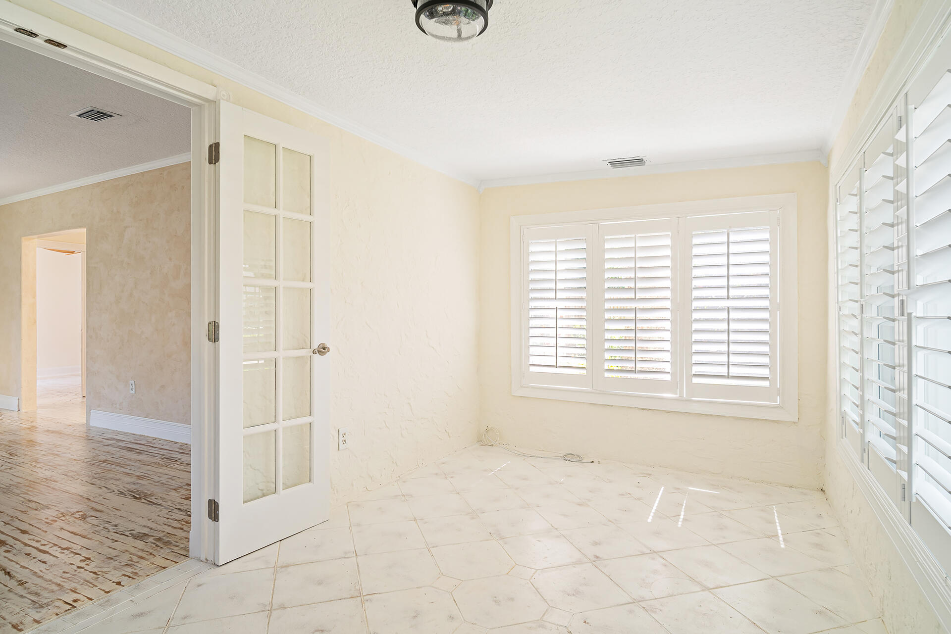 813 Avon Road West Palm Beach, FL 33401 - Photo 5 of 43 a view of an empty room with a window