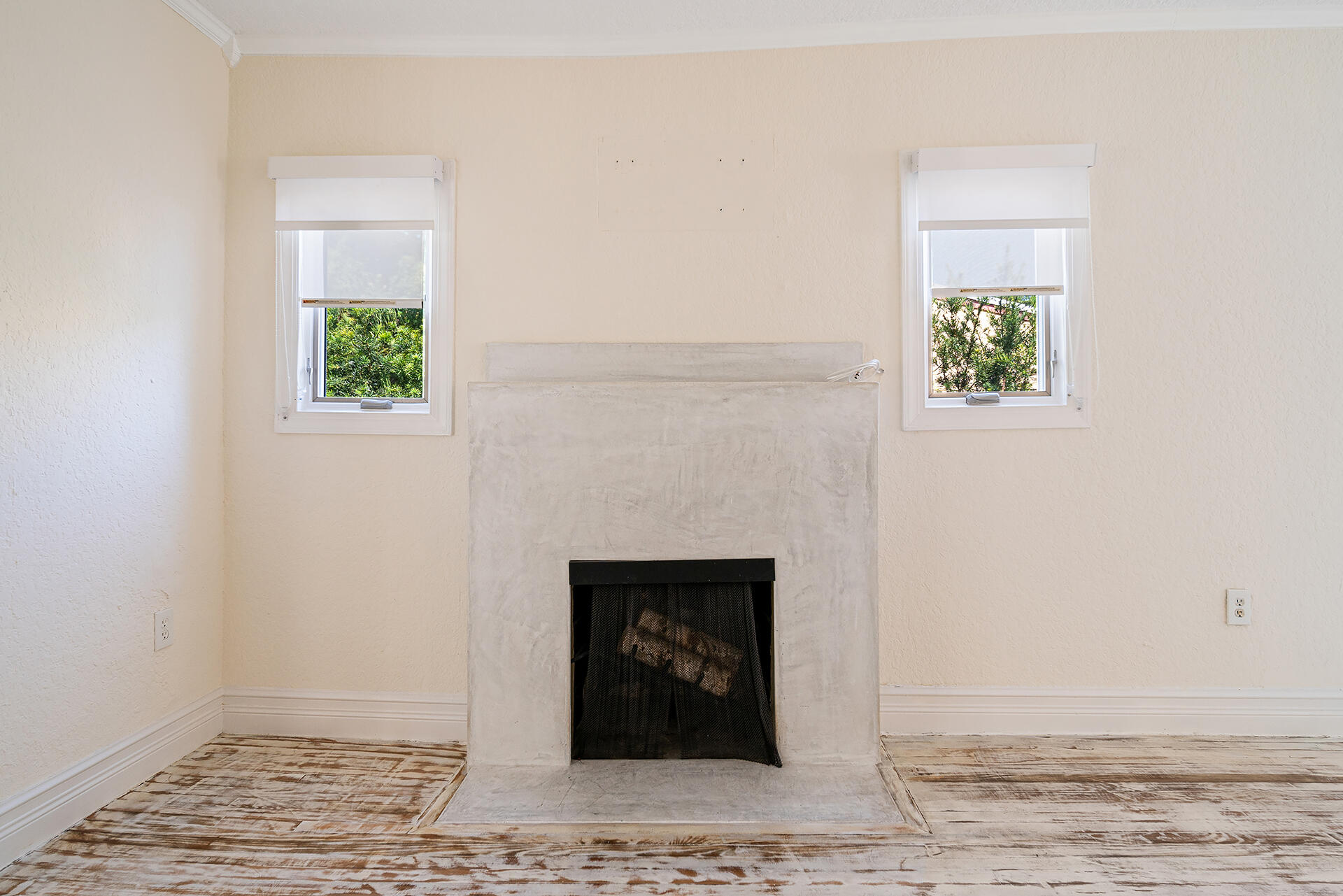 813 Avon Road West Palm Beach, FL 33401 - Photo 9 of 43 a view of an empty room with wooden floor and a fireplace