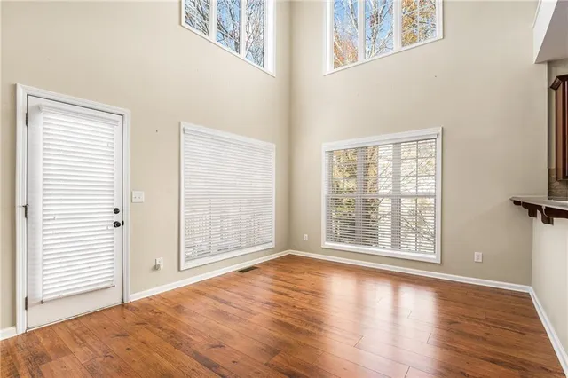 a view of a balcony with wooden floor and fence