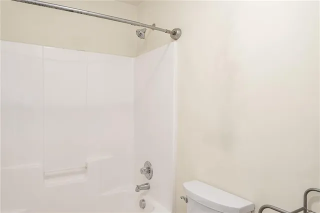 a view of a hallway with entryway and wooden floor