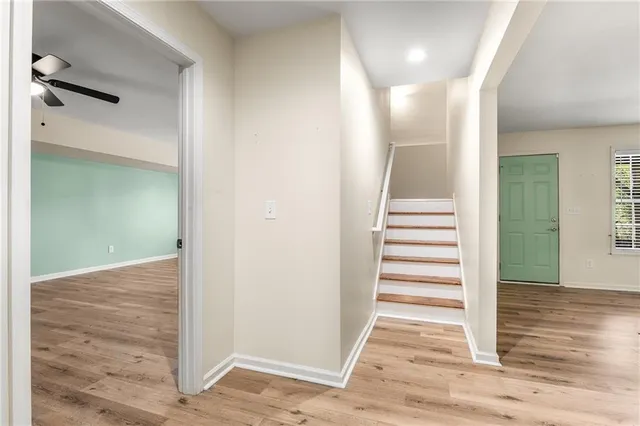 a kitchen with stainless steel appliances a sink cabinets and wooden floor