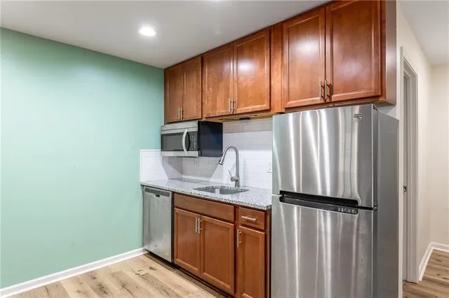 a view of a patio with table and chairs with wooden floor and fence