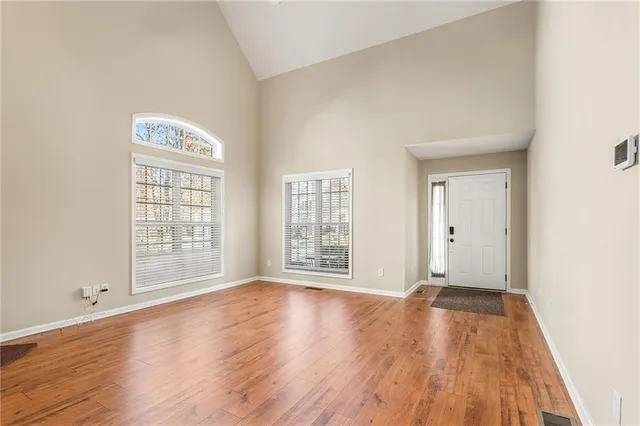 a large kitchen with stainless steel appliances granite countertop a sink and dishwasher wooden cabinets with a large window