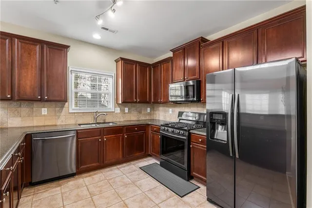 a kitchen with granite countertop a sink and a window