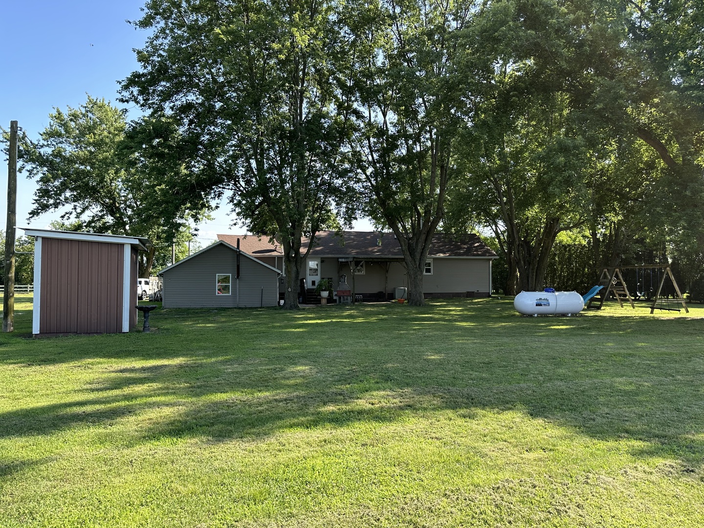 10600 Osage Road Prophetstown, IL 61277 - Photo 15 of 17 a backyard of a house with a garden and plants