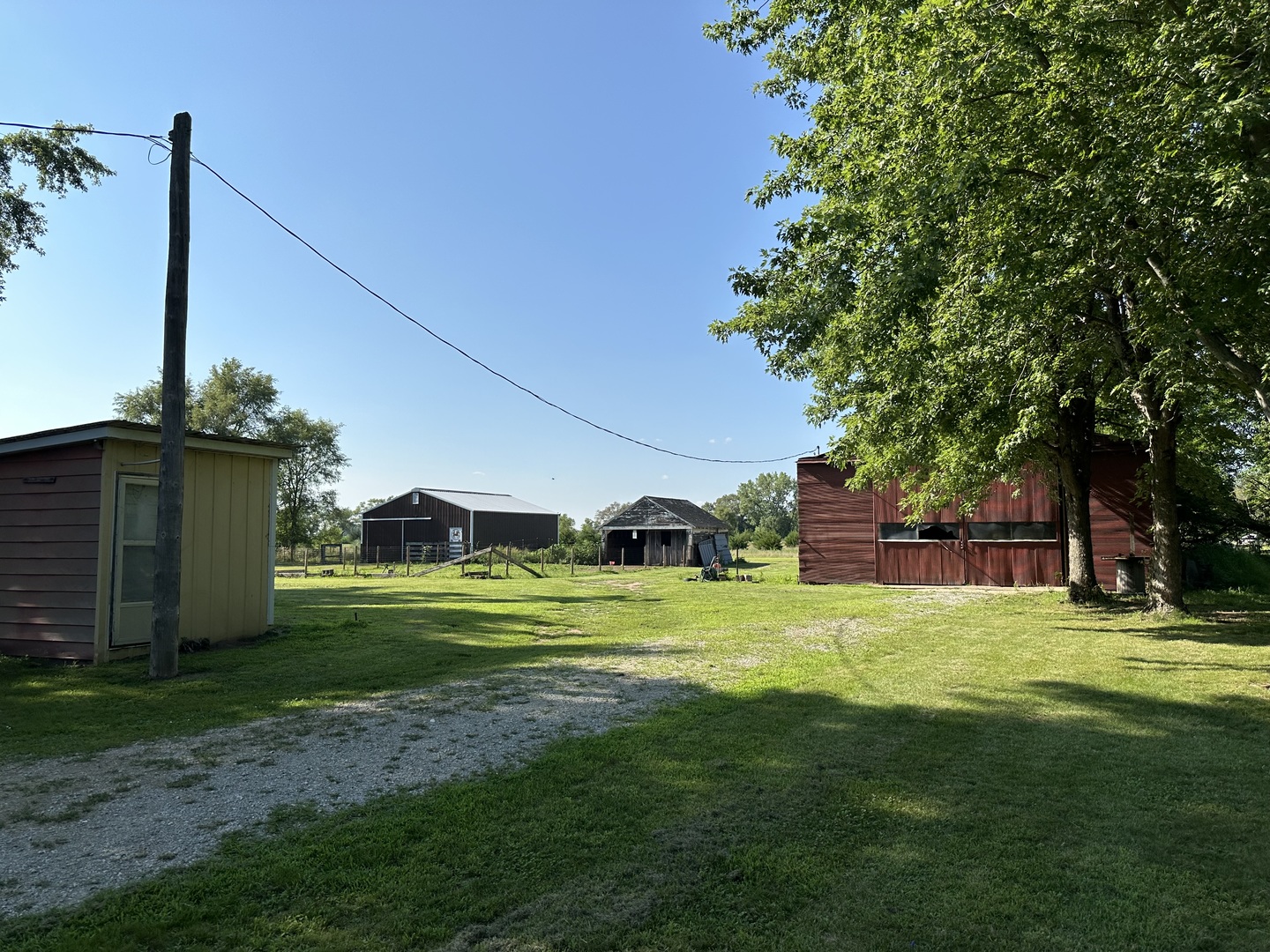 10600 Osage Road Prophetstown, IL 61277 - Photo 16 of 17 a view of a big house with a big yard and palm trees