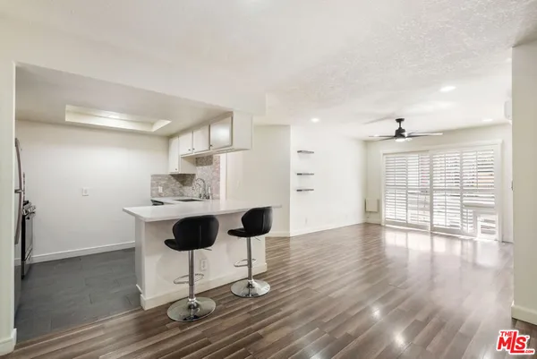 a view of wooden floor and windows in an empty room