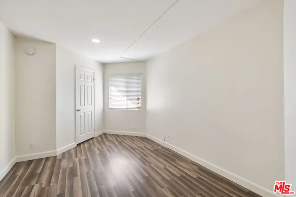a view of a room with wooden floor and white walls