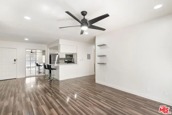 a living room with kitchen island furniture and a wooden floor