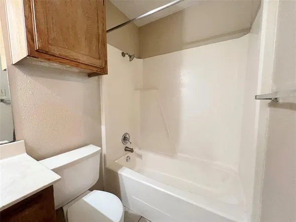 a bathroom with a toilet and a bathtub