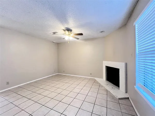 a view of an empty room with a fireplace