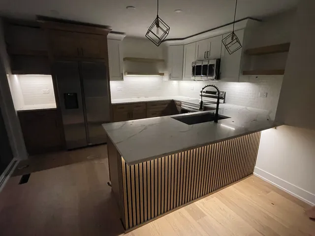 a kitchen with a sink a refrigerator and washer