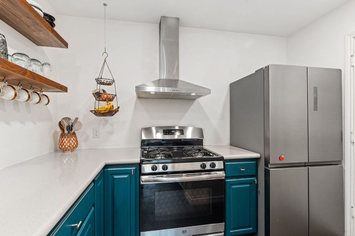 6016 Baton Rouge Drive Austin, TX 78727 - Photo 16 of 29 The stainless gas range with sleek exhaust hood are a welcome site for cooks!