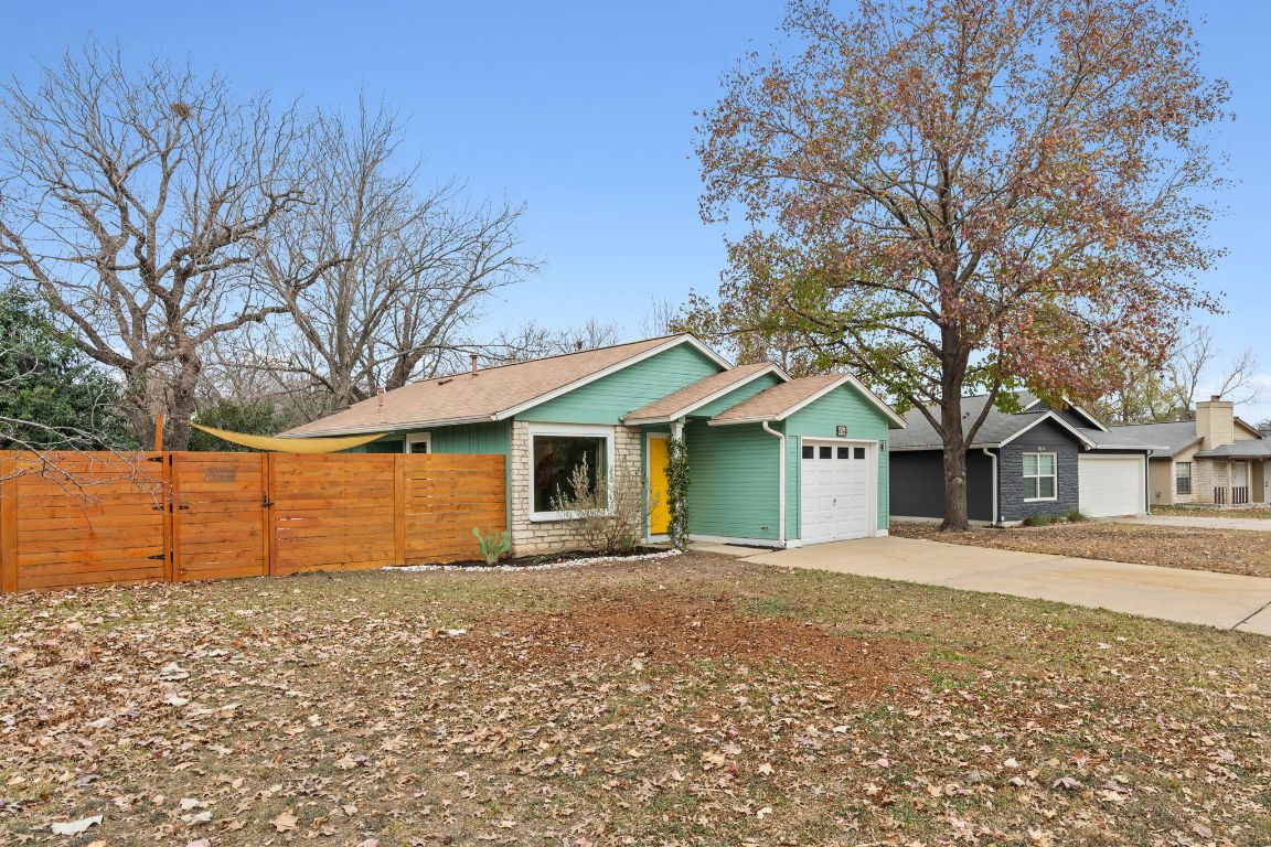 6016 Baton Rouge Drive Austin, TX 78727 - Photo 27 of 29 The front yard and newer fence with gate to the private side yard offer eminently usable spaces.