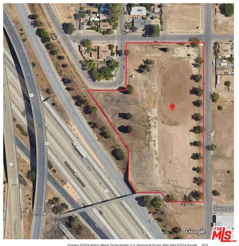 a picture of a room with a white wall and bed