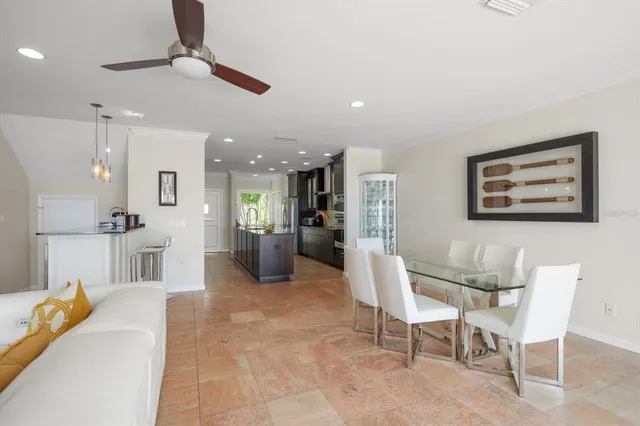 a living room with furniture and kitchen view