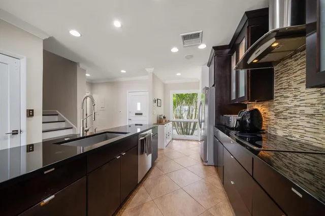 a kitchen with granite countertop a sink and stove