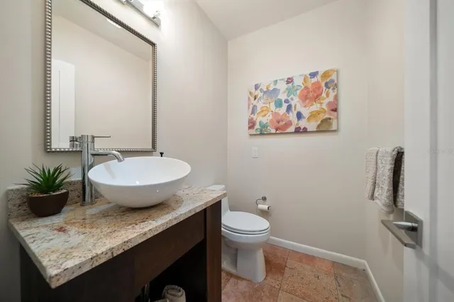 a view of bathroom with a toilet sink and mirror