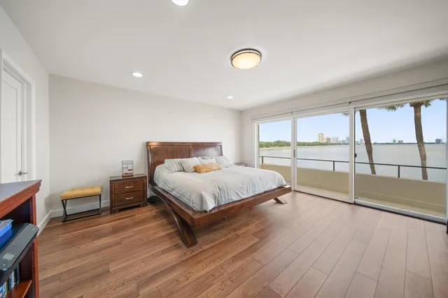 a bedroom with a bed and a large window