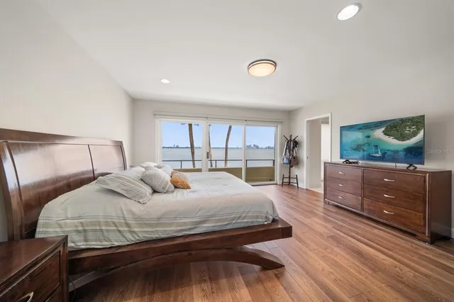 a bedroom with a bed and large window