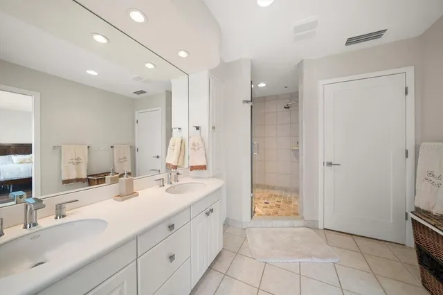 a spacious bathroom with a double vanity sink mirror and double