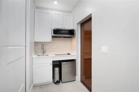 a kitchen with stainless steel appliances a sink and cabinets
