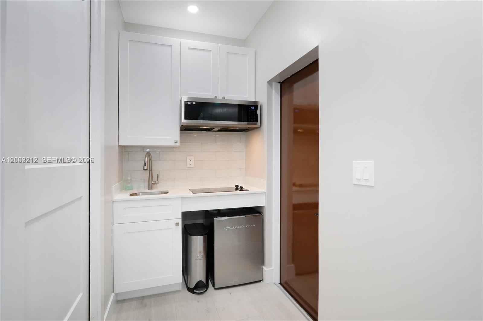 2368 Southwest 21st Street Miami, FL 33145 - Photo 3 of 8 a kitchen with stainless steel appliances a sink and cabinets