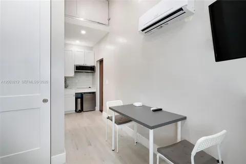 a kitchen with a refrigerator and a table